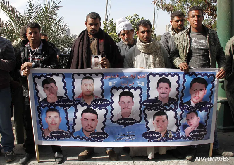Relatives of kidnapped Egyptian in Libya, hold their pictures during a protest outside the United Nations headquarters, in Cairo on January 19, 2015. Thirteen Egyptians were kidnapped in the Libyan city of Sirte, adding...