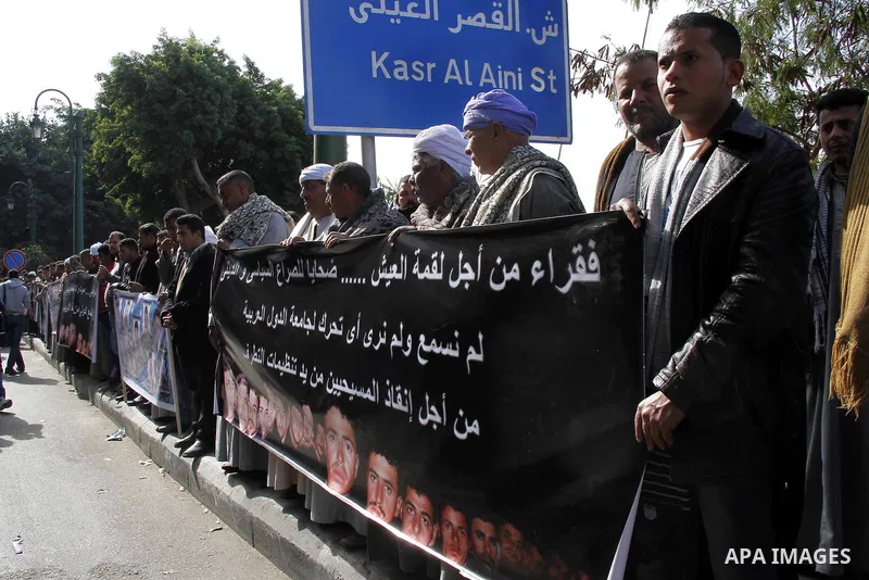 Relatives of kidnapped Egyptian in Libya, hold their pictures during a protest outside the United Nations headquarters, in Cairo on January 19, 2015. Thirteen Egyptians were kidnapped in the Libyan city of Sirte, adding...
