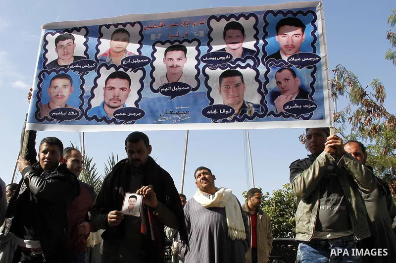 Relatives of kidnapped Egyptian in Libya, hold their pictures during a protest outside the United Nations headquarters, in Cairo on January 19, 2015. Thirteen Egyptians were kidnapped in the Libyan city of Sirte, adding...