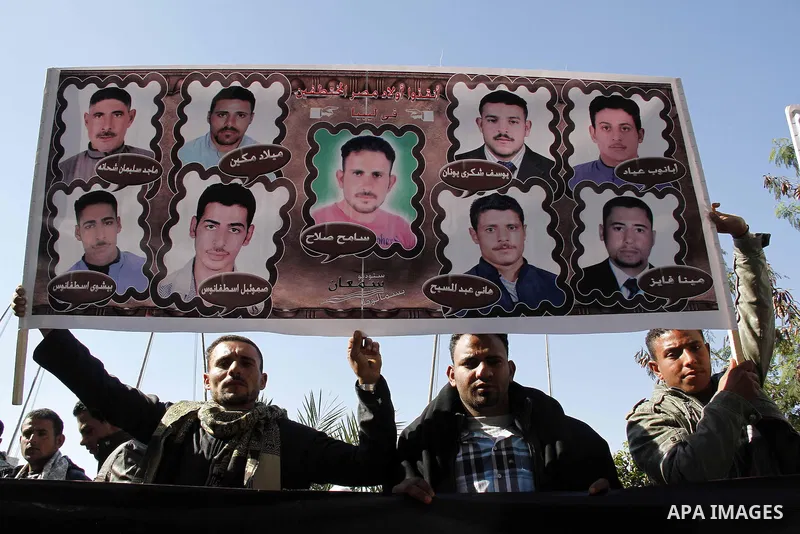 Relatives of kidnapped Egyptian in Libya, hold their pictures during a protest outside the United Nations headquarters, in Cairo on January 19, 2015. Thirteen Egyptians were kidnapped in the Libyan city of Sirte, adding...