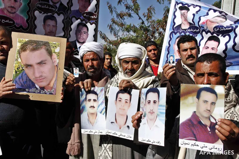 Relatives of kidnapped Egyptian in Libya, hold their pictures during a protest outside the United Nations headquarters, in Cairo on January 19, 2015. Thirteen Egyptians were kidnapped in the Libyan city of Sirte, adding...