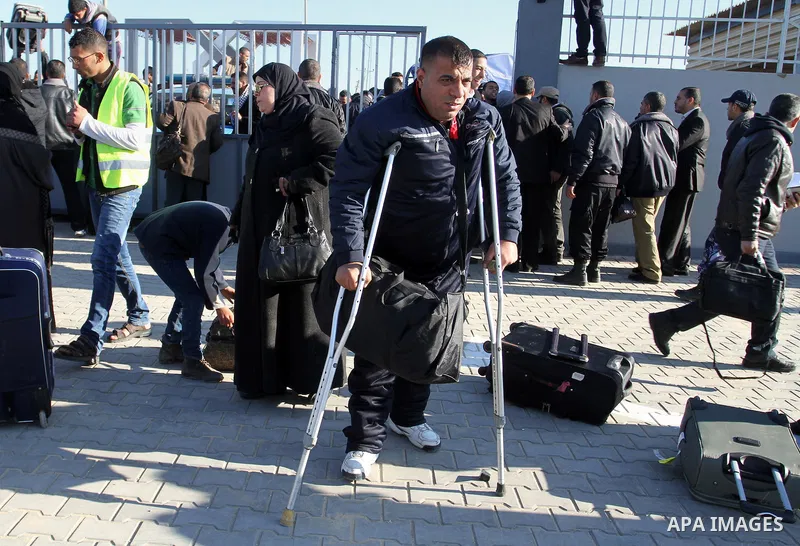 Palestinians, hoping to cross into Egypt , as they wait at the Rafah crossing between Egypt and the southern Gaza Strip January 20, 2015. Egyptian authorities opened Rafah crossing, Gaza's main window to the outside worl...