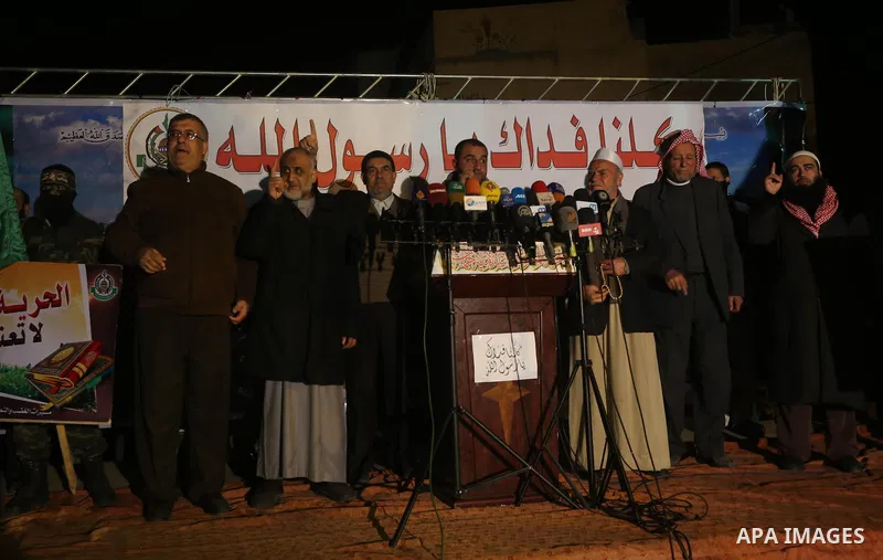 Palestinians take part in a protest against a cartoon of the Prophet Mohammed that was published by the French satirical magazine Charlie Hebdo in an edition issued a week after 12 people were killed by Islamist gunmen a...