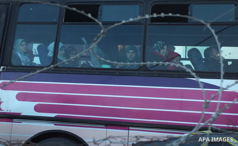 Palestinians look out a bus window as they wait to cross into Egypt at the Rafah crossing between Egypt and the southern Gaza Strip January 21, 2015. Egyptian authorities opened the Rafah border crossing on Tuesday for t...