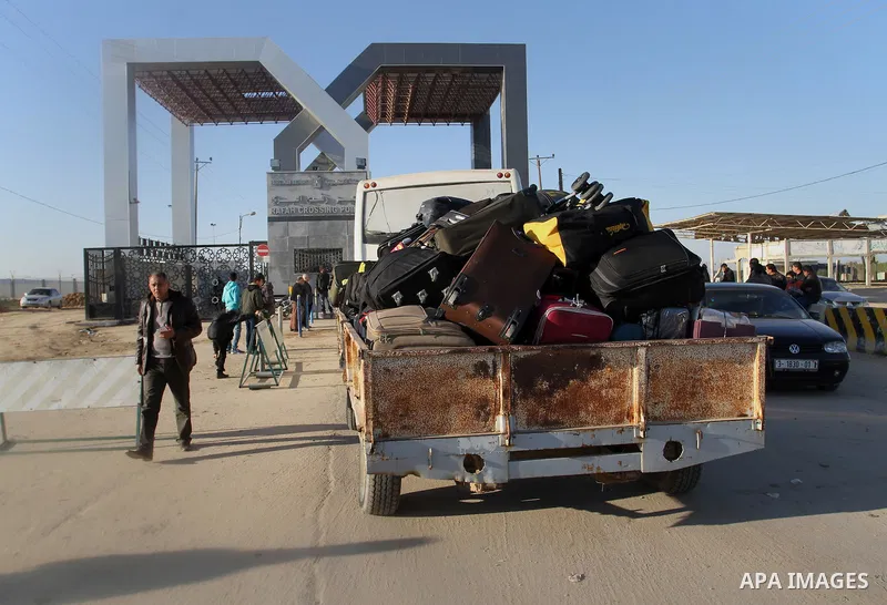 Palestinians, hoping to cross into Egypt, wait for a travel permit at the Rafah crossing between Egypt and the southern Gaza Strip January 22, 2015. Egyptian authorities opened the Rafah border crossing on Tuesday for th...