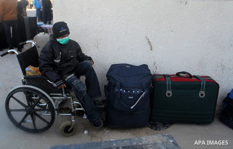 A Wheelchair-bound Palestinian, hoping to cross into Egypt, waits for a travel permit at the Rafah crossing between Egypt and the southern Gaza Strip January 22, 2015. Egyptian authorities opened the Rafah border crossin...