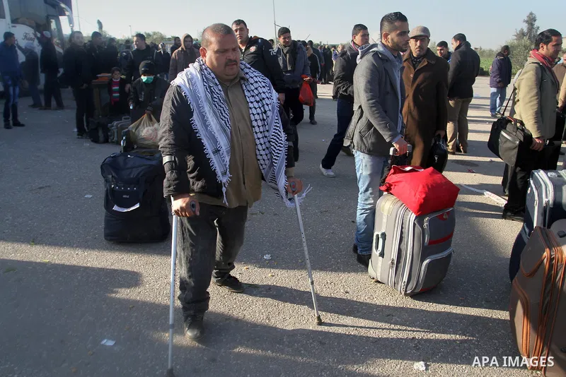 Palestinians, hoping to cross into Egypt, wait for a travel permit at the Rafah crossing between Egypt and the southern Gaza Strip January 22, 2015. Egyptian authorities opened the Rafah border crossing on Tuesday for th...