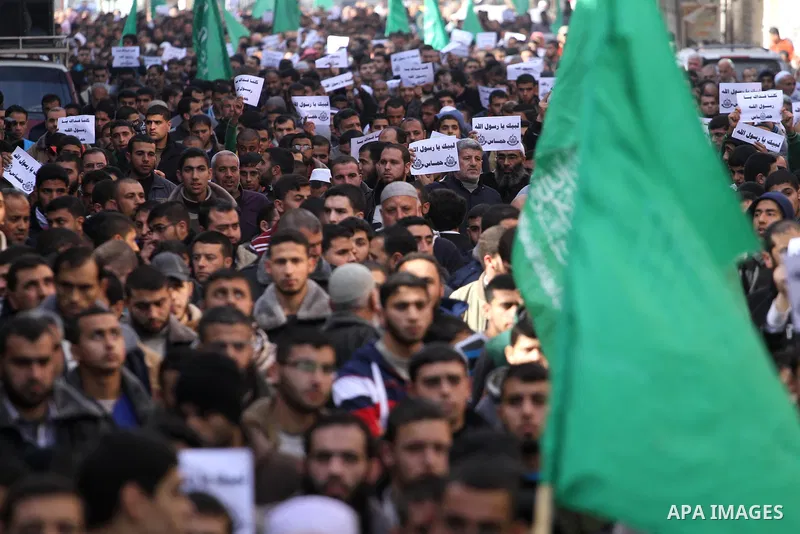 Palestinians hold placards and shout slogans praising Islam's Prophet Mohammed during a demonstration organised by Islamist movement Hamas against the cover cartoon of the Prophet published by French satirical magazine C...