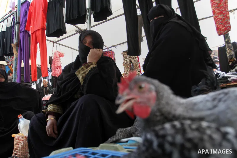 A Palestinian vendor displays the chickens at the main market in Rafah in the southern Gaza Strip on January 24, 2015. Photo by Abed Rahim Khatib