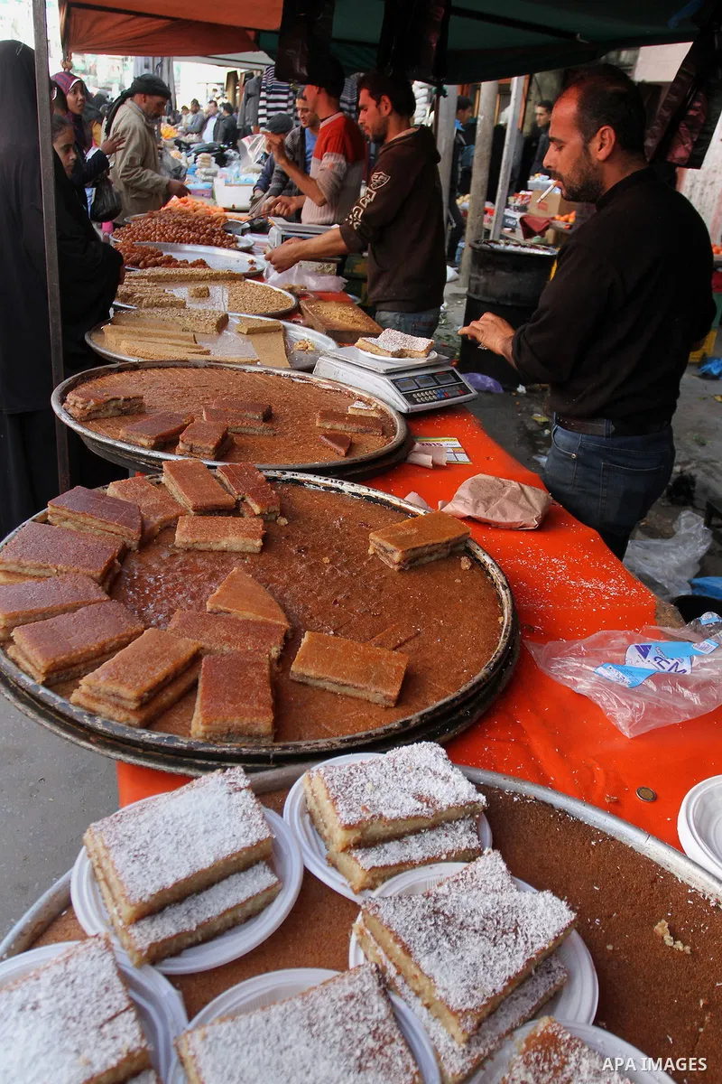 A Palestinian vendor displays the sweets at the main market in Rafah in the southern Gaza Strip on January 24, 2015. Photo by Abed Rahim Khatib