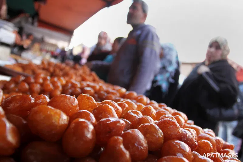 A Palestinian vendor displays the sweets at the main market in Rafah in the southern Gaza Strip on January 24, 2015. Photo by Abed Rahim Khatib