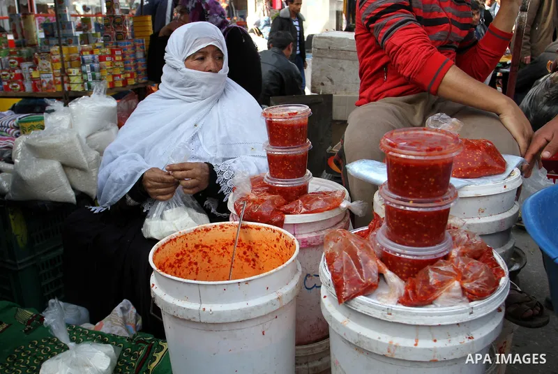 A Palestinian vendor displays the goods at the main market in Rafah in the southern Gaza Strip on January 24, 2015. Photo by Abed Rahim Khatib