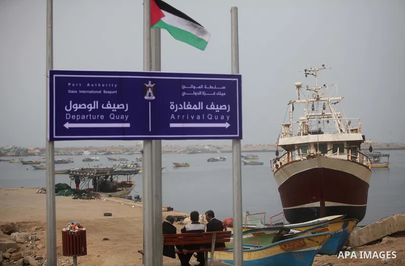 A placard read the Gaza international seaport is seen in Gaza city, on January 25, 2015. The governmental Committee to Break the Siege on Gaza declared last week the beginning of the rehabilitation of a waterway that wou...
