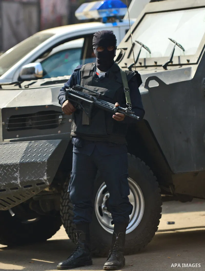 An Egyptian security force stands guard at Faisal street in Cairo January 25, 2015. A bomb wounded two Egyptian policemen in Cairo on Sunday and security forces moved quickly to disperse small protests on the anniversary...