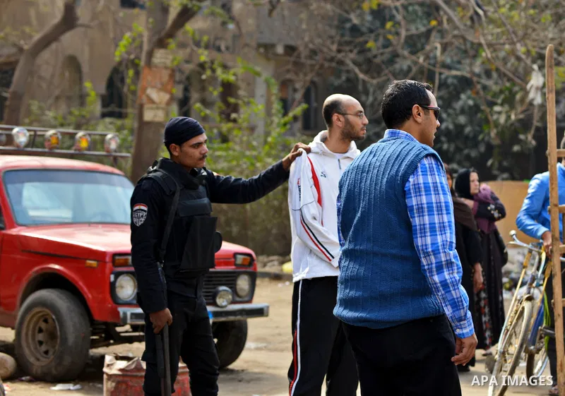 Egyptian security forces detain a member of Muslim Brotherhood movement in Cairo on January 25, 2015. A protester was killed in Egypt and a bomb wounded two policemen on Sunday, the anniversary of the 2011 uprising that...