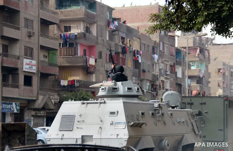A member of Egyptian security forces stand on a military vehicle in Mataryah destrict, in Cairo on January 25, 2015. A protester was killed in Egypt and a bomb wounded two policemen on Sunday, the anniversary of the 2011...