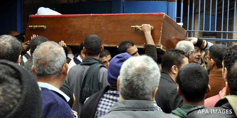 Mourners carry a body of an Egyptian protester, who was killed by security forces a day before, outside a hospital morgue, in Cairo on January 26, 2015. The death toll from clashes between protesters and police as Egypt...