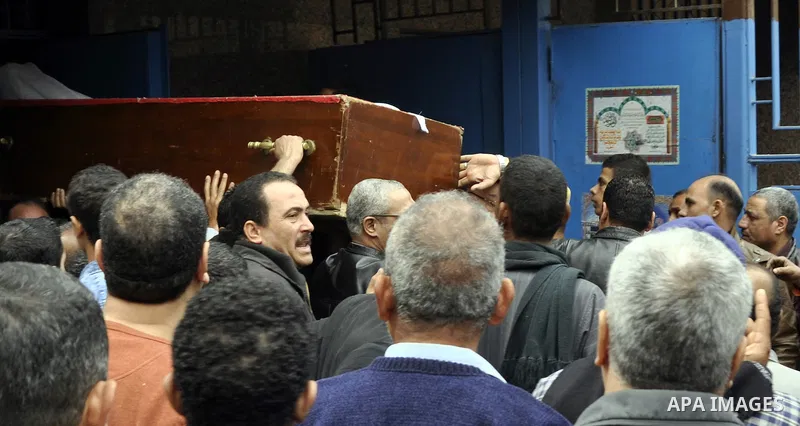 Mourners carry a body of an Egyptian protester, who was killed by security forces a day before, outside a hospital morgue, in Cairo on January 26, 2015. The death toll from clashes between protesters and police as Egypt...