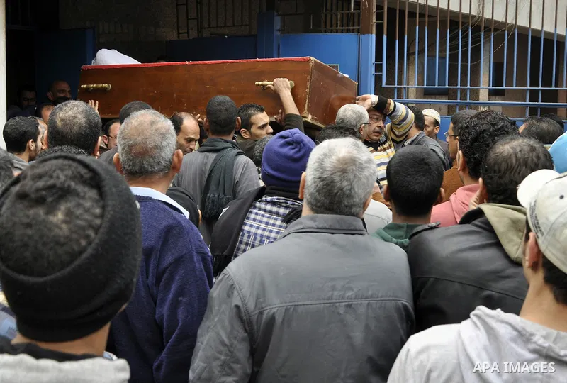 Mourners carry a body of an Egyptian protester, who was killed by security forces a day before, outside a hospital morgue, in Cairo on January 26, 2015. The death toll from clashes between protesters and police as Egypt...