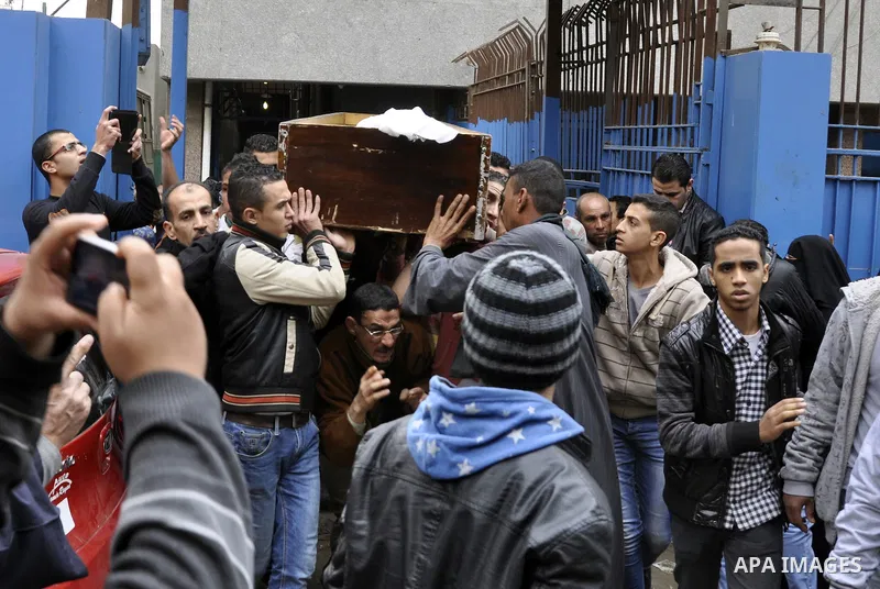 Mourners carry a body of an Egyptian protester, who was killed by security forces a day before, outside a hospital morgue, in Cairo on January 26, 2015. The death toll from clashes between protesters and police as Egypt...