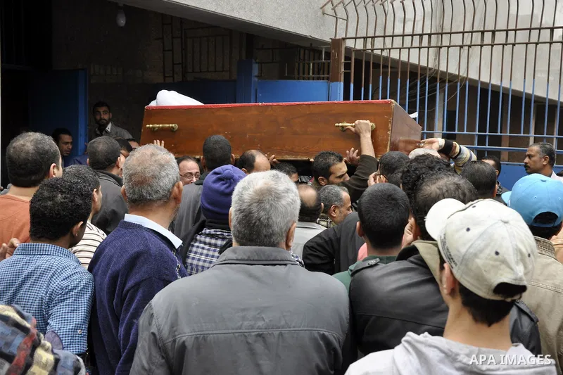 Mourners carry a body of an Egyptian protester, who was killed by security forces a day before, outside a hospital morgue, in Cairo on January 26, 2015. The death toll from clashes between protesters and police as Egypt...