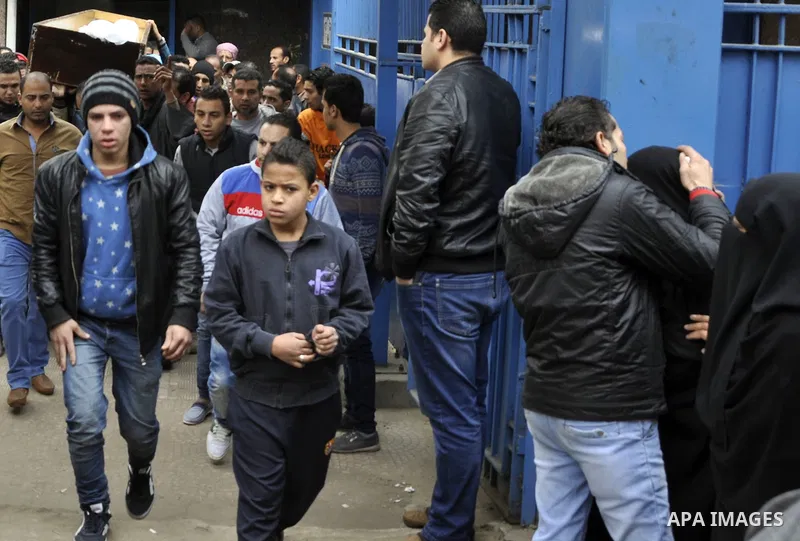 Mourners carry a body of an Egyptian protester, who was killed by security forces a day before, outside a hospital morgue, in Cairo on January 26, 2015. The death toll from clashes between protesters and police as Egypt...