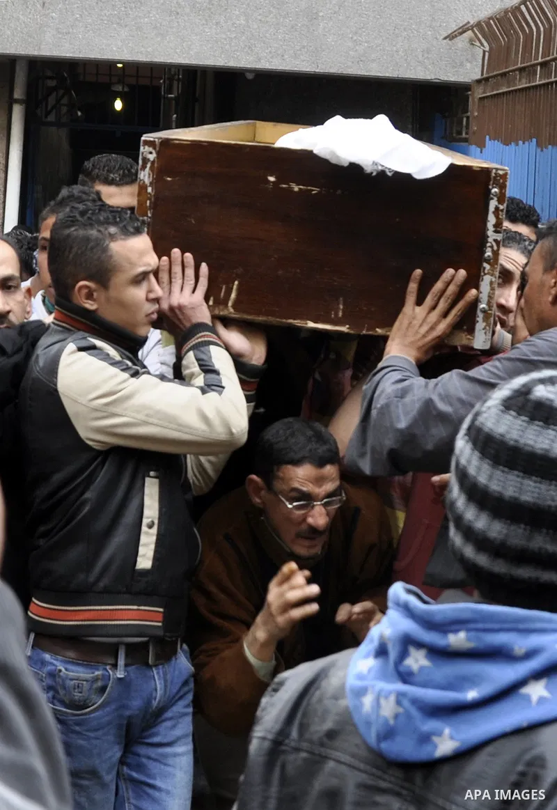 Mourners carry a body of an Egyptian protester, who was killed by security forces a day before, outside a hospital morgue, in Cairo on January 26, 2015. The death toll from clashes between protesters and police as Egypt...