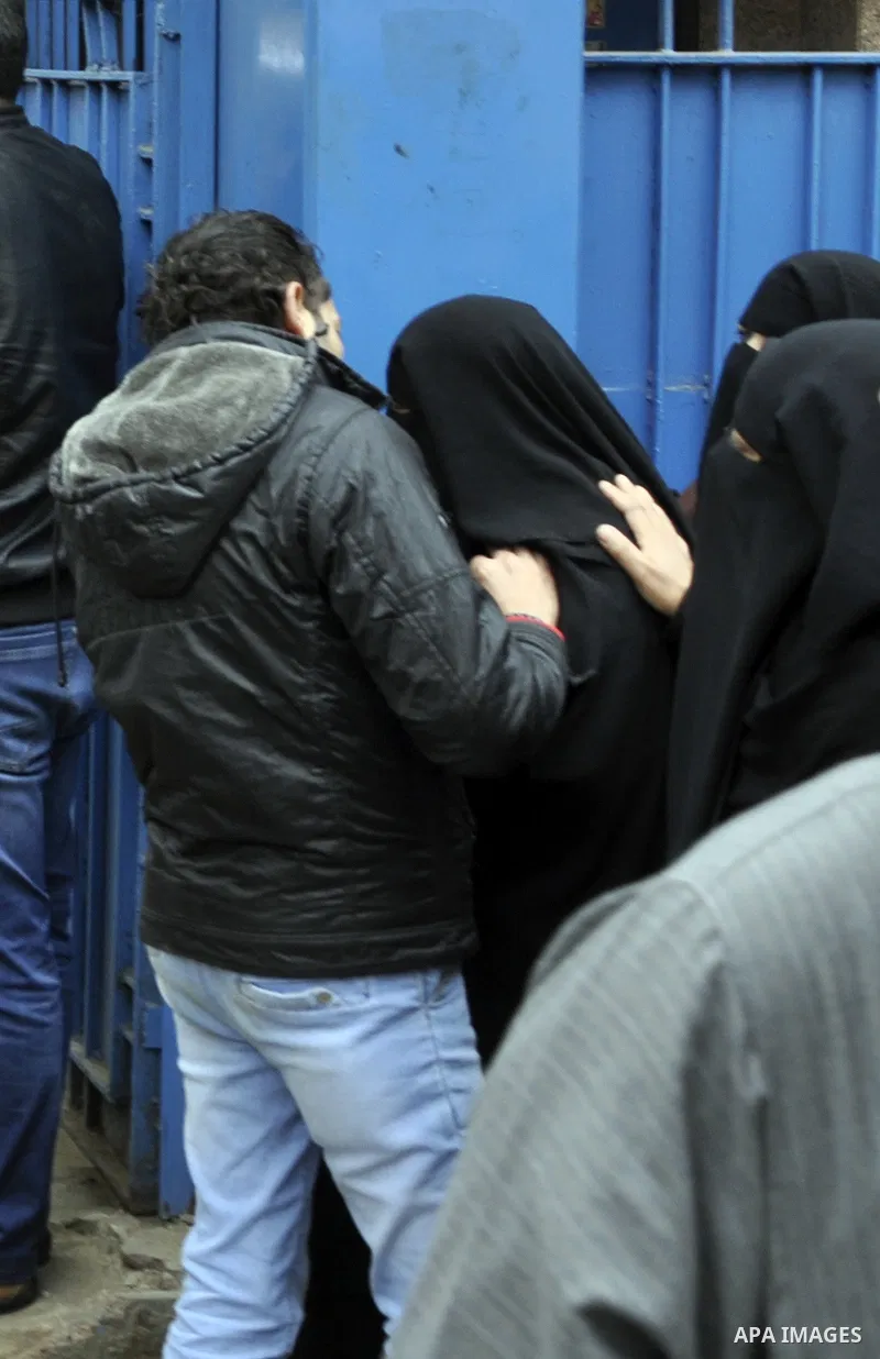 Egyptians mourn their relatives, who were killed by security forces a day before, outside a hospital morgue, in Cairo on January 26, 2015. The death toll from clashes between protesters and police as Egypt marked the fou...