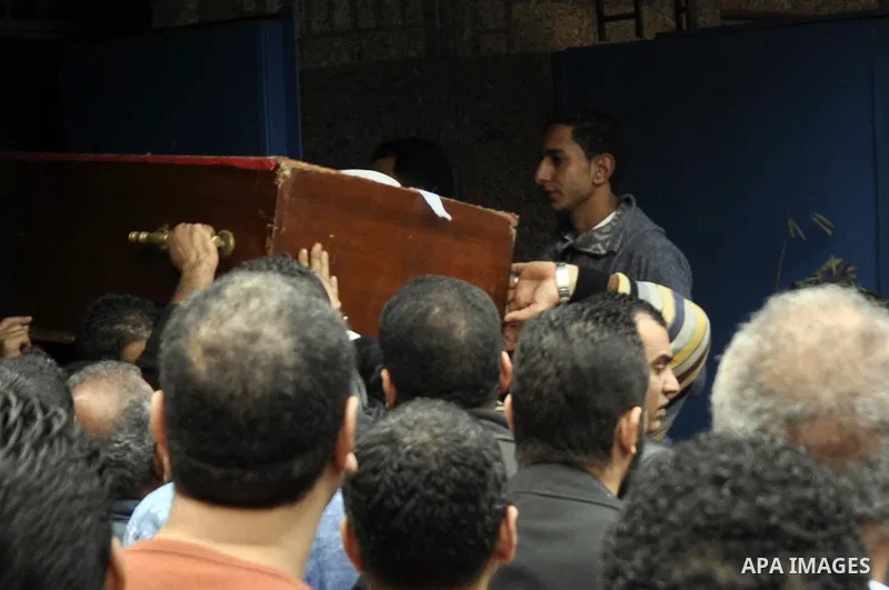 Mourners carry a body of an Egyptian protester, who was killed by security forces a day before, outside a hospital morgue, in Cairo on January 26, 2015. The death toll from clashes between protesters and police as Egypt...