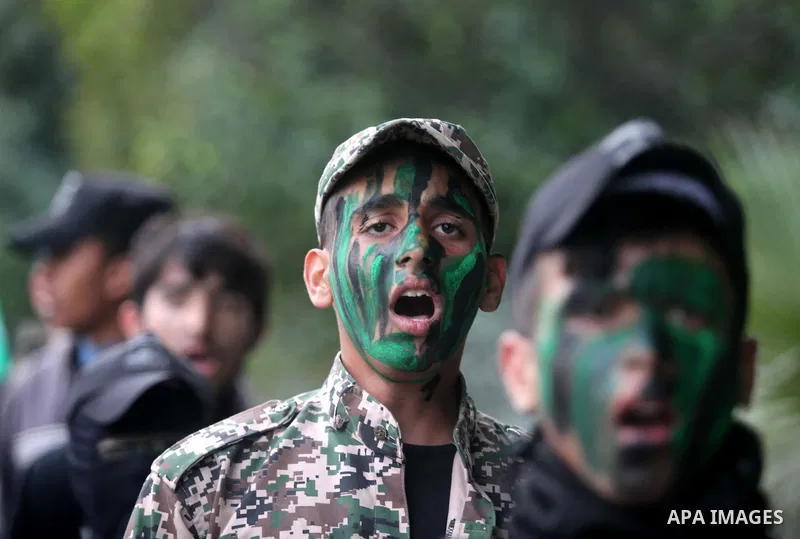 Palestinian youths, who are participants in a Hamas military-style camp, march during a rally against the cover cartoon of the Prophet Mohammed published by French satirical magazine Charlie Hebdo in Gaza city on January...