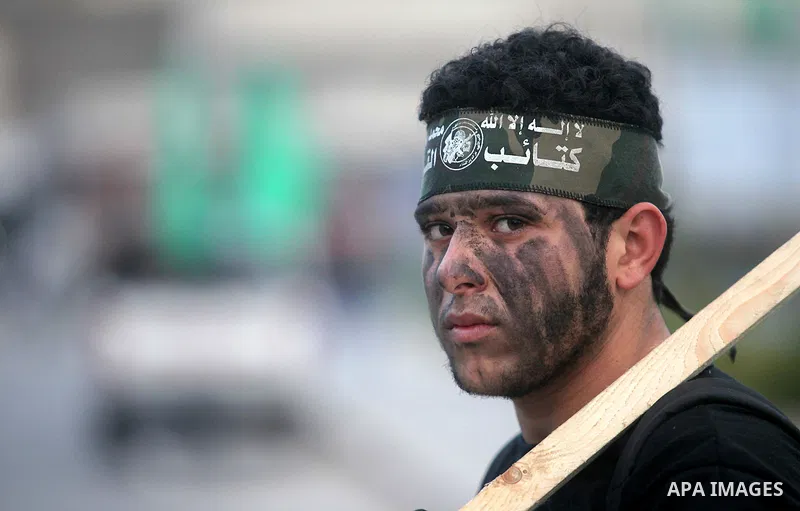 A Palestinian youth, who is a participant in a Hamas military-style camp, looks on during a rally against the cover cartoon of the Prophet Mohammed published by French satirical magazine Charlie Hebdo in Gaza city on Jan...