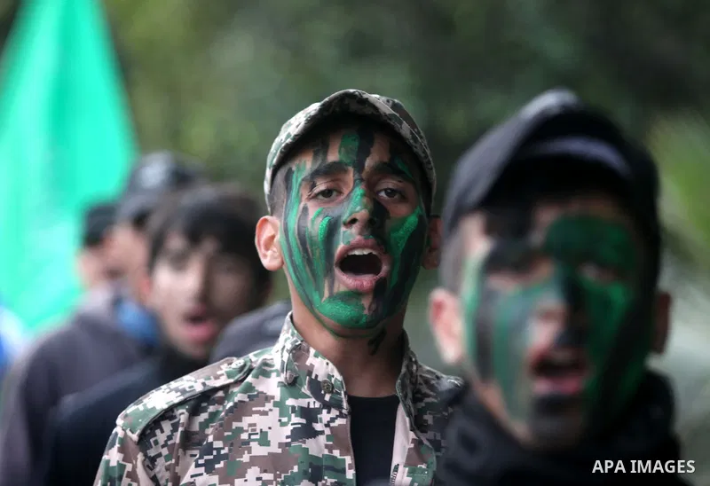 Palestinian youths, who are participants in a Hamas military-style camp, march during a rally against the cover cartoon of the Prophet Mohammed published by French satirical magazine Charlie Hebdo in Gaza city on January...