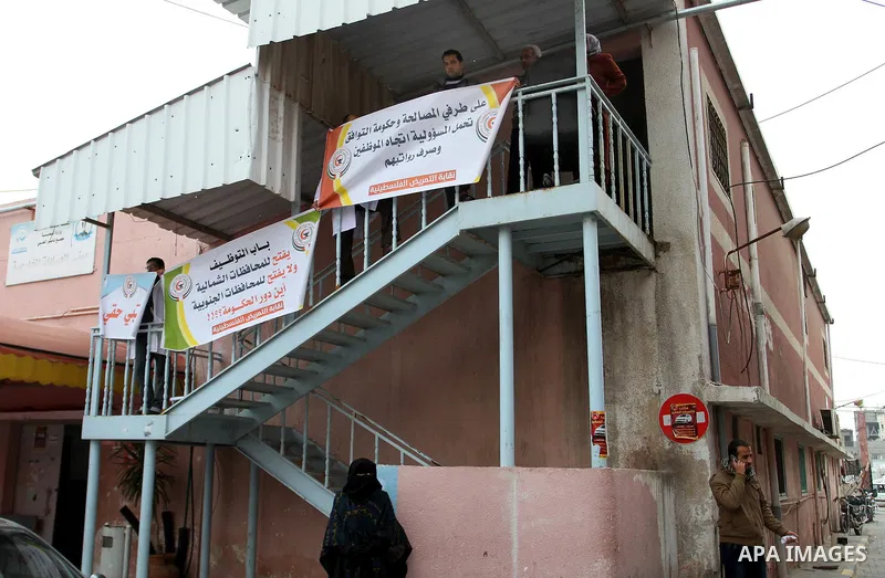 Palestinian doctors and workers of the health sector hold placards during a protest calling the government for pay their salaries, at Nasser hospital in Khan Younis in the southern Gaza Strip on January 26, 2015. Photo b...