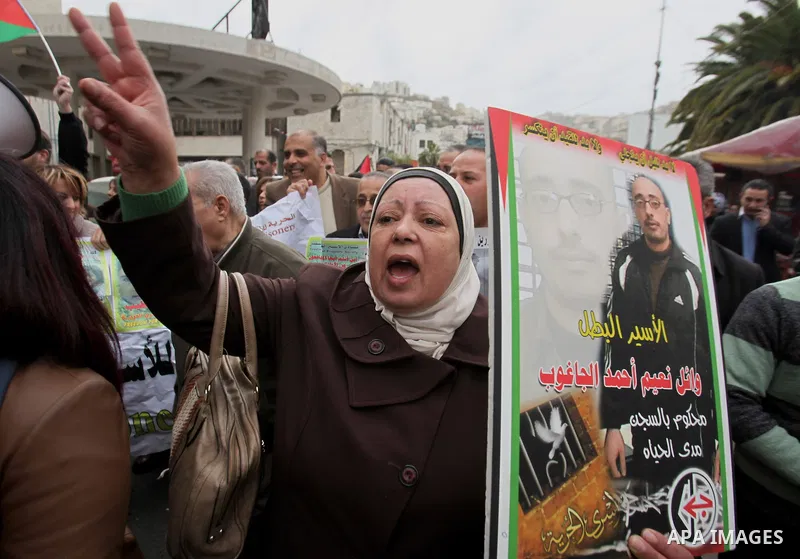 Palestinians hold banners during a protest to show solidarity with prisoners in Israeli jails, in the West Bank city of nablus, on January 27, 2015. Malak Khatib, has been in Israeli detention since December 31,2014. She...