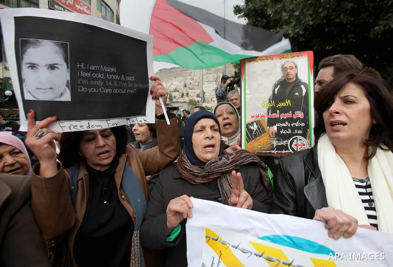 Palestinians hold banners during a protest to show solidarity with prisoners in Israeli jails, in the West Bank city of nablus, on January 27, 2015. Malak Khatib, has been in Israeli detention since December 31,2014. She...