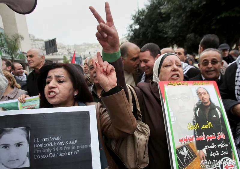 Palestinians hold banners during a protest to show solidarity with prisoners in Israeli jails, in the West Bank city of nablus, on January 27, 2015. Malak Khatib, has been in Israeli detention since December 31,2014. She...