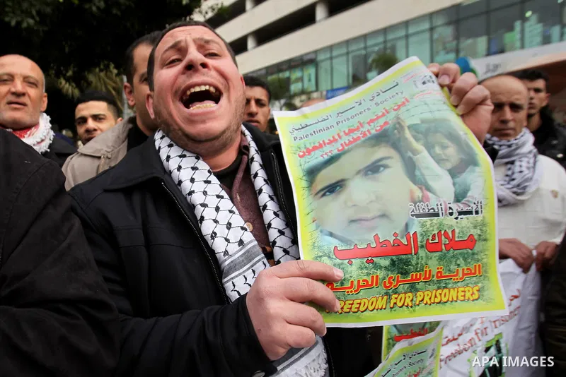 A Palestinian man holds poster during a protest to show solidarity with the prisoner of Malak Khatib in Israeli jails, in the West Bank city of nablus, on January 27, 2015. Malak Khatib, has been in Israeli detention sin...