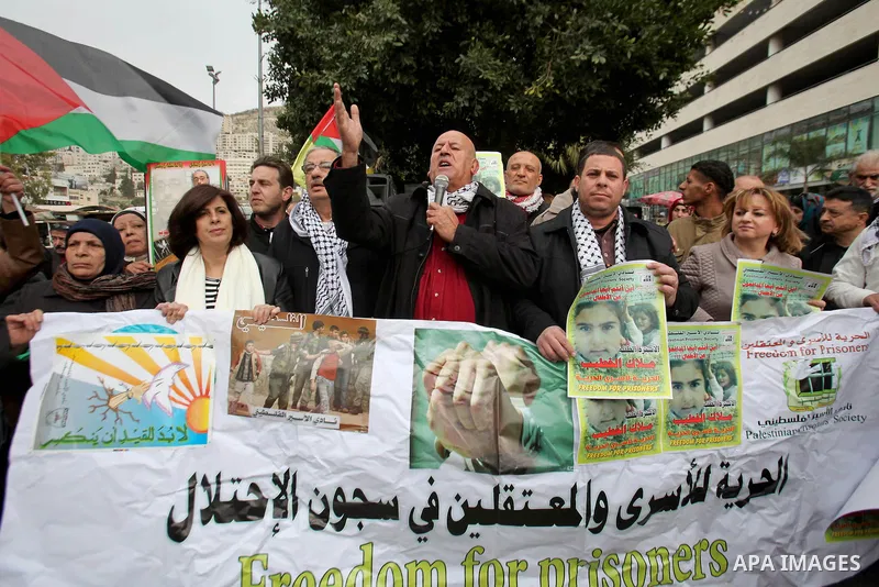 Palestinians hold banners during a protest to show solidarity with prisoners in Israeli jails, in the West Bank city of nablus, on January 27, 2015. Malak Khatib, has been in Israeli detention since December 31,2014. She...
