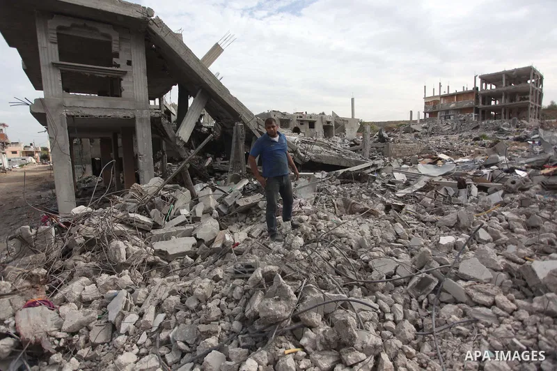 A Palestinian man works next to the rubbles of houses that witnesses said was destroyed by Israeli shelling during the most recent conflict between Israel and Hamas, in Shijaiyah neighborhood, east Gaza city on January 2...