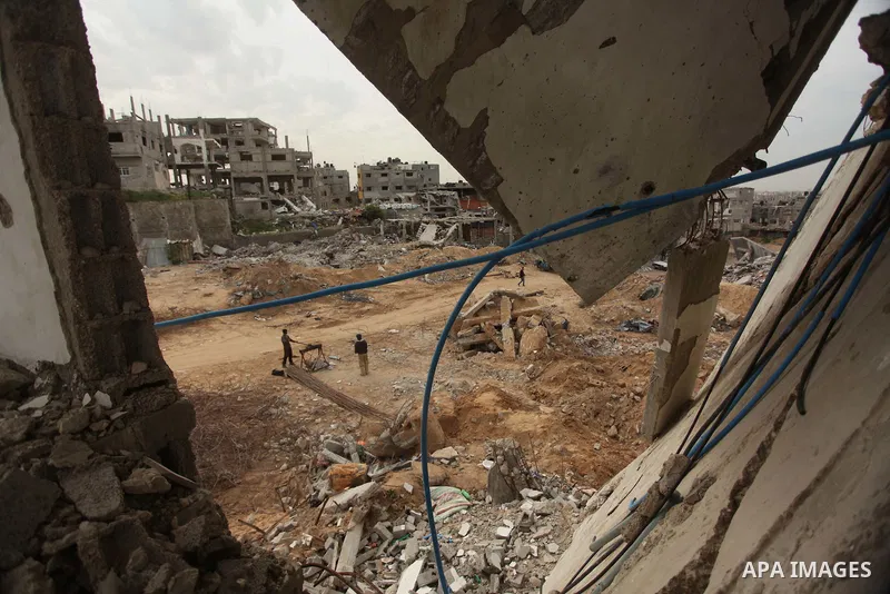 Palestinian workers extract iron from the rubbles of houses that witnesses said was destroyed by Israeli shelling during the most recent conflict between Israel and Hamas, in Shijaiyah neighborhood, east Gaza city on Jan...