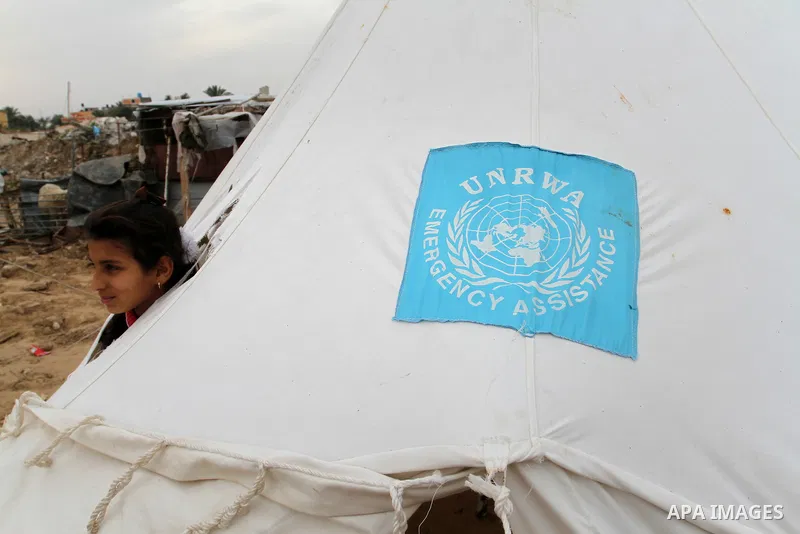 A Palestinian girl plays at a tent near the ruins of her family's house which witnesses said were destroyed by Israel shelling during a 50-day conflict last summer, east of Khan Younis in the southern Gaza Strip January...
