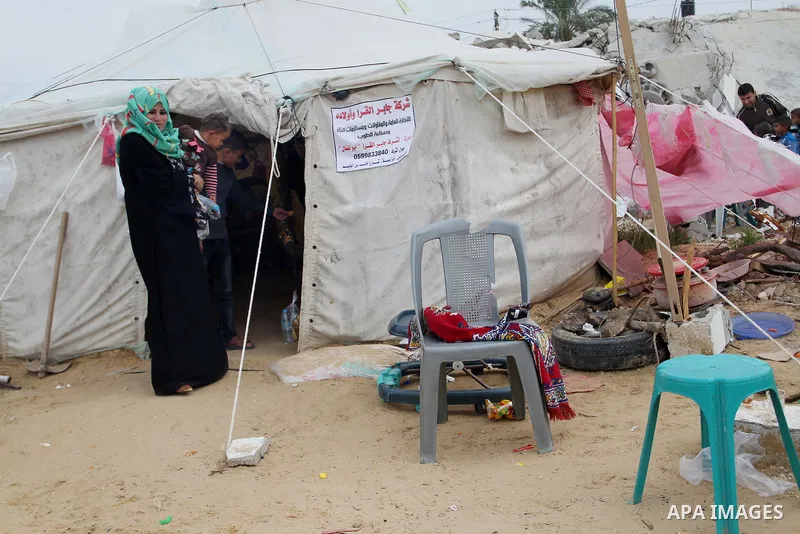 A Palestinian woman, whose house was destroyed by what witnesses said was Israel shelling during a 50-day conflict last summer, stands outside her tent east of Khan Younis in the southern Gaza Strip January 27, 2015. The...