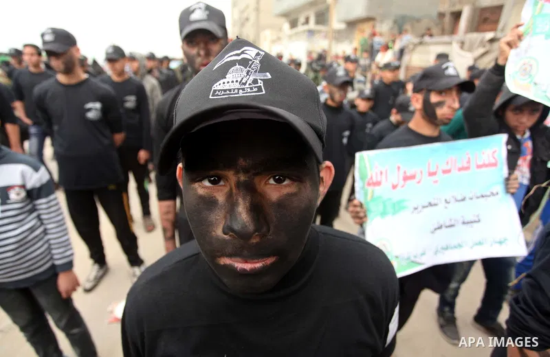 Palestinian youth, who are participating in a Hamas military-style camp, march during a protest rally in support of the Prophet Mohammed in Gaza City on January 27, 2015. Photo by Ashraf Amra