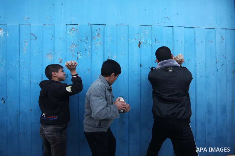 Palestinian protesters attack the headquarters of the United Nations in Gaza city on January 28, 2015 after the UN announced a lack of funds to rebuild the Palestinian territory. Around 200 people demonstrated outside he...