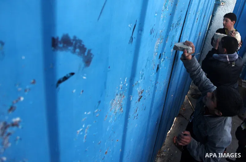 Palestinian protesters attack the headquarters of the United Nations in Gaza city on January 28, 2015 after the UN announced a lack of funds to rebuild the Palestinian territory. Around 200 people demonstrated outside he...