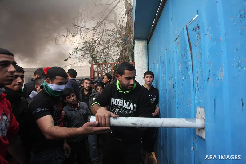 Palestinian protesters attack the headquarters of the United Nations in Gaza city on January 28, 2015 after the UN announced a lack of funds to rebuild the Palestinian territory. Around 200 people demonstrated outside he...