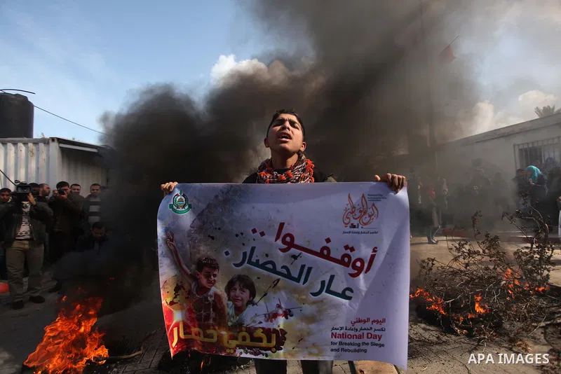 Palestinian protesters attack the headquarters of the United Nations in Gaza city on January 28, 2015 after the UN announced a lack of funds to rebuild the Palestinian territory. Around 200 people demonstrated outside he...