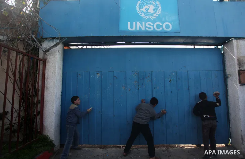 Palestinian protesters attack the headquarters of the United Nations in Gaza city on January 28, 2015 after the UN announced a lack of funds to rebuild the Palestinian territory. Around 200 people demonstrated outside he...