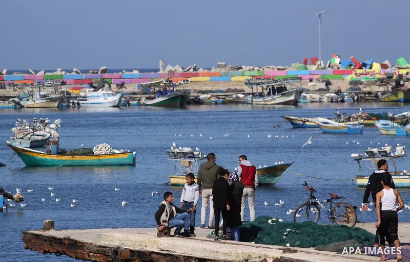Palestinian fishermen ride their boats into the water in the port of Gaza City on January 29, 2015. The governmental Committee to Break the Siege on Gaza declared last week the beginning of the rehabilitation of a waterw...