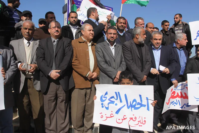 Palestinian factions members take part a protest at the Gaza seaport, on January 29, 2015. The governmental Committee to Break the Siege on Gaza declared last week the beginning of the rehabilitation of a waterway that w...